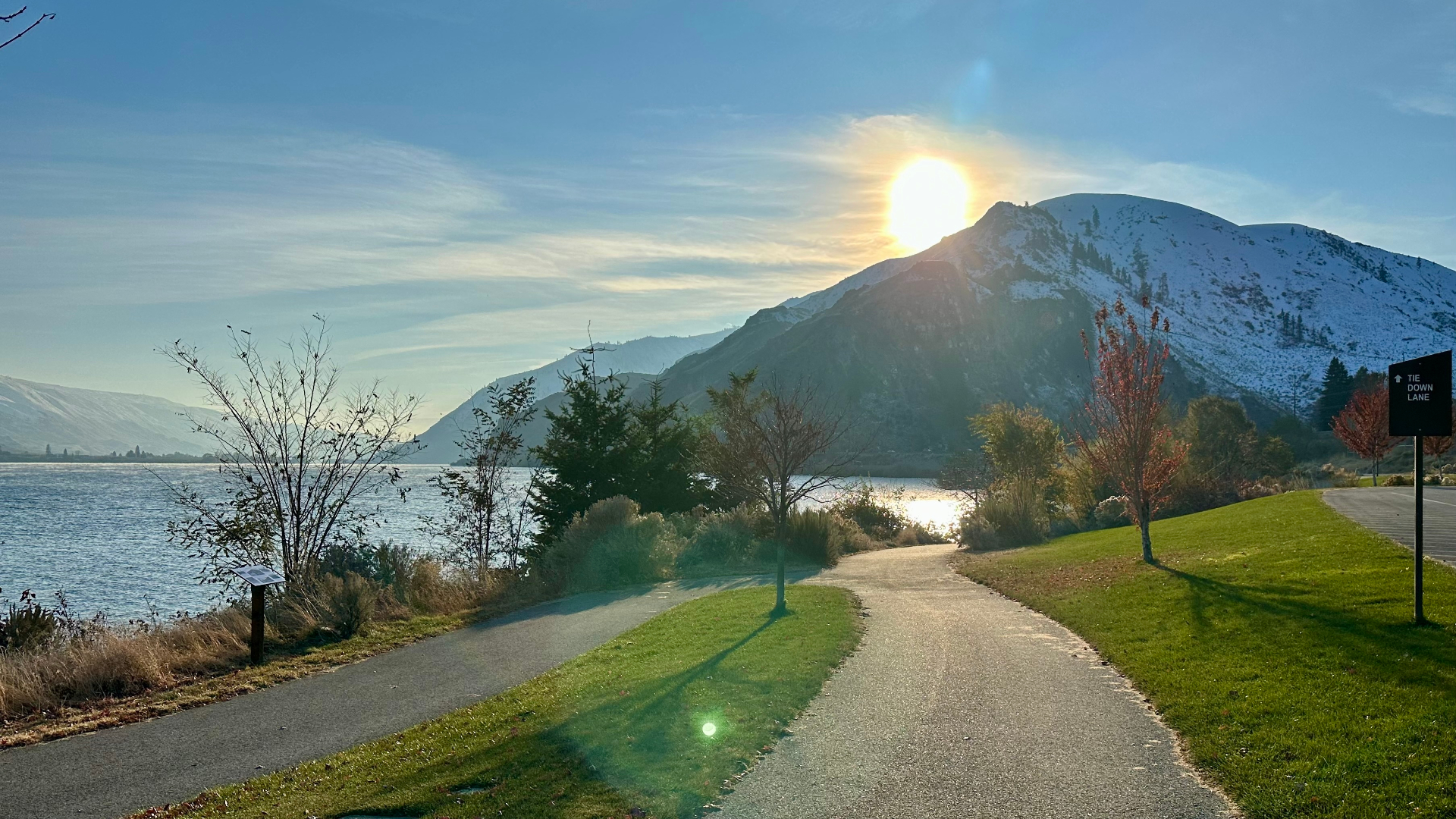Lake Chelan waterfront path at sunrise with snow-dusted mountains
