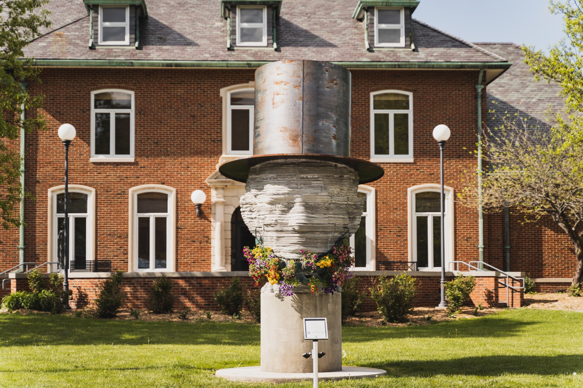 Lincoln top hat sculpture in front of a historic brick building