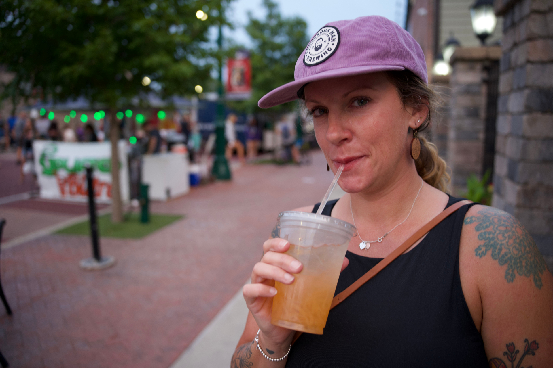 Visitor enjoying a drink at a downtown street festival