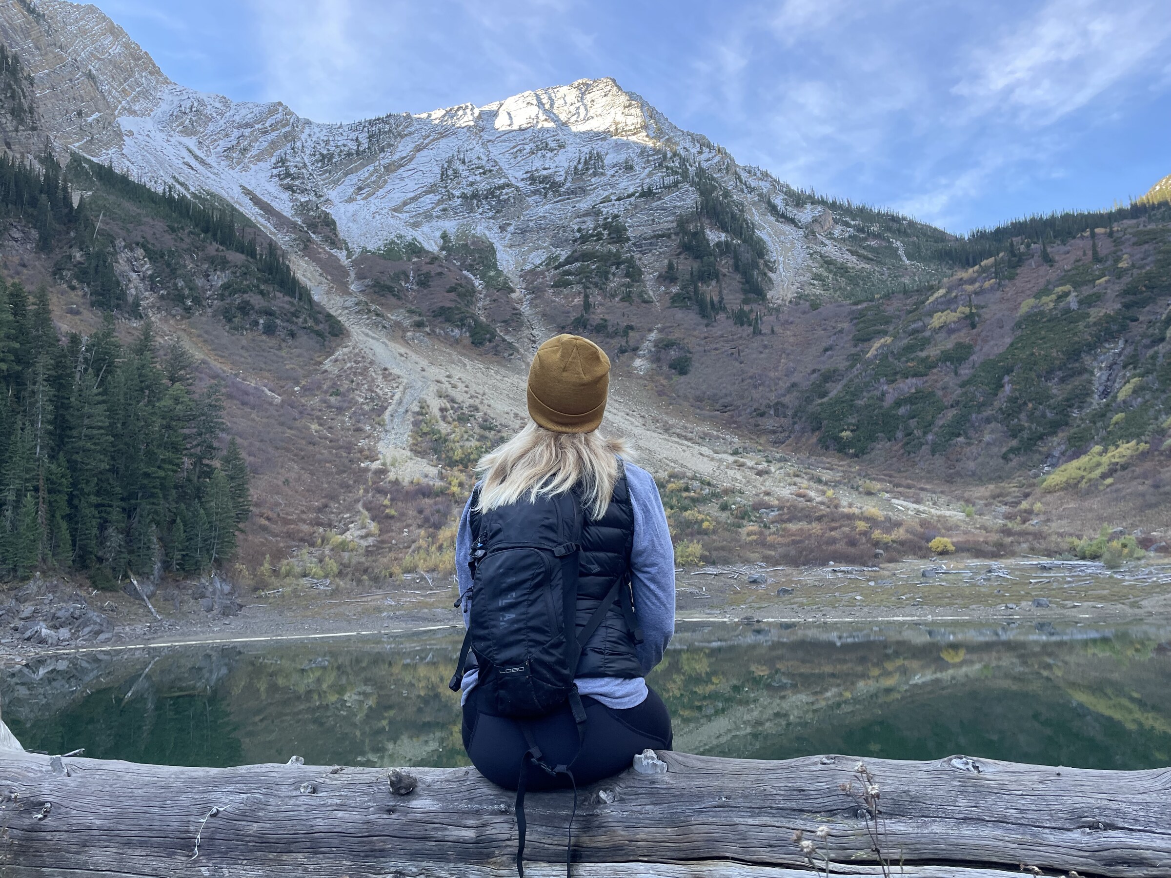 A traveler at a mountain overlook at golden hour